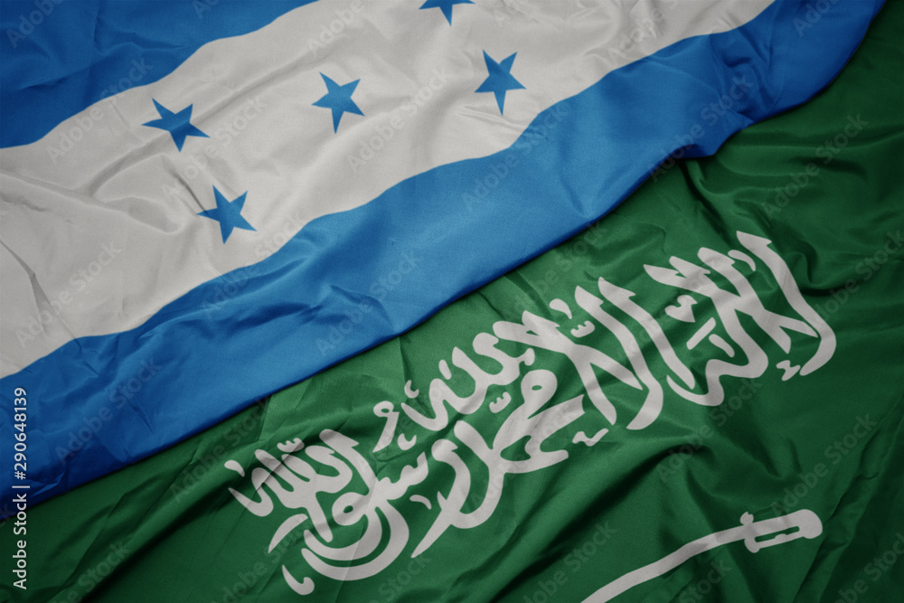 waving colorful flag of saudi arabia and national flag of honduras.