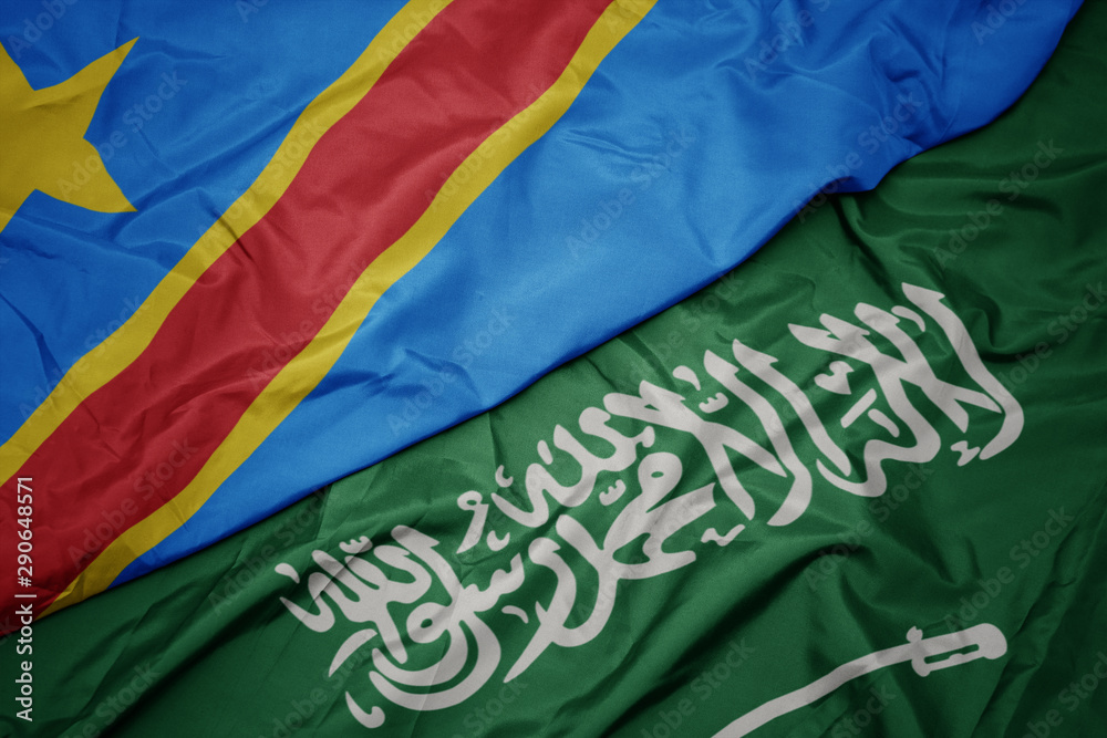 waving colorful flag of saudi arabia and national flag of democratic republic of the congo.