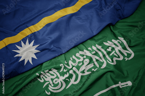 waving colorful flag of saudi arabia and national flag of Nauru .