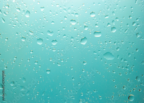 Close-up shot of water drop on transparent glass after raining.