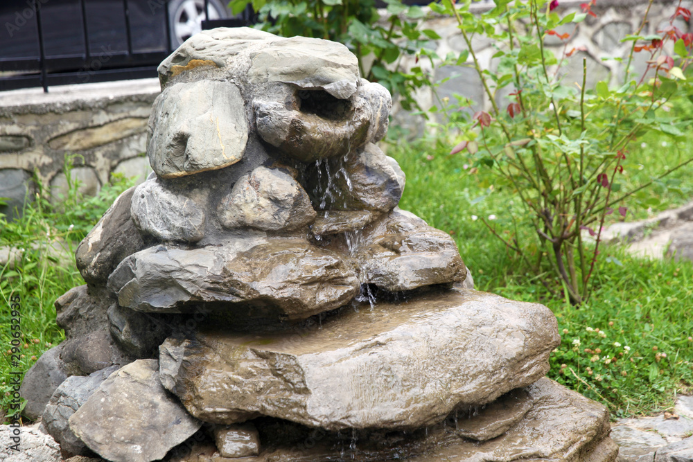Beautiful fountain of stones in the garden in Sheki
