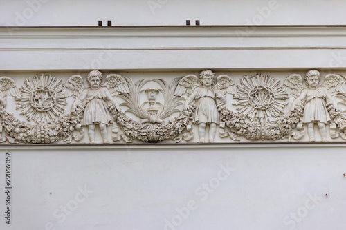 Bas-relief with images of angels on facade of Trinity cathedral in St. Petersburg, Russia