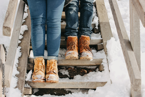 The crop photo of young couple at the nature park in cold season. Travel adventure love story photo