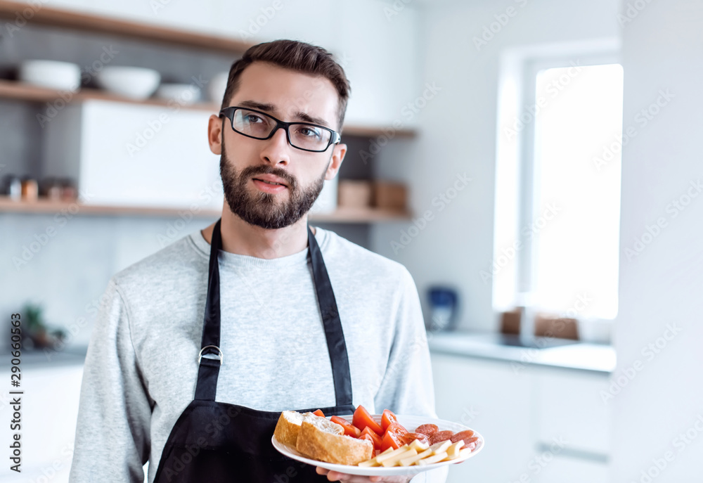 plate of sandwiches in the hands of an attractive man