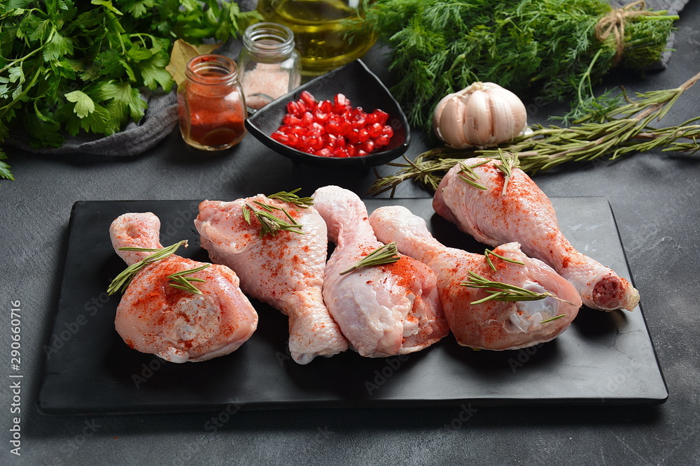 Raw uncooked chicken legs for barbecue grill with salt, herbs, garlic and olive oil. Meat with ingredients for cooking Raw uncooked chicken legs for barbecue grill with salt, herbs, garlic and olive oil. Meat with ingredients for cooking