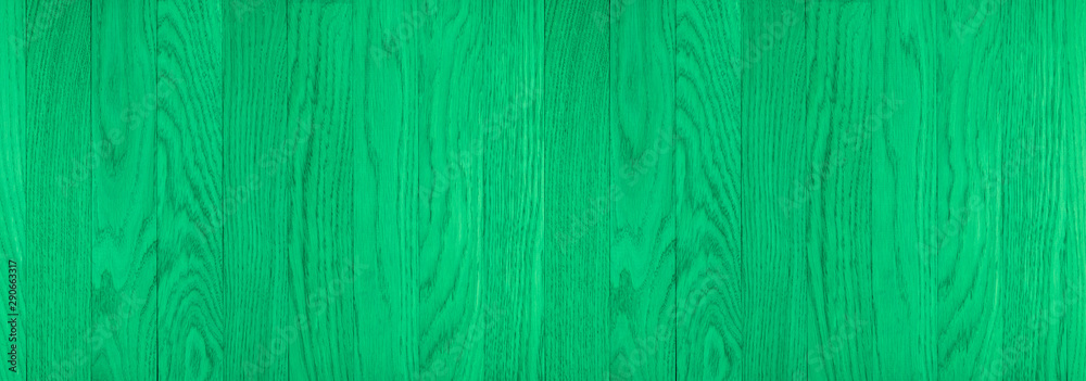 The texture of green from old wooden planks arranged in a vertical order. 