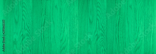 The texture of green from old wooden planks arranged in a vertical order. 