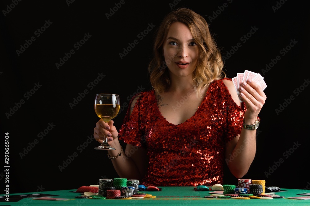 Poker girl wins a jackpot in a casino. On a black background. Winning in a casino. Poker girl wins a jackpot in a casino. On a black background. Winning in a casino.