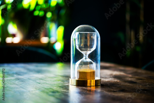 Landscape Close up hourglass on wooden background
