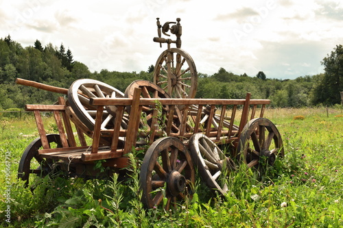 Wooden old cart with wheels in the field.