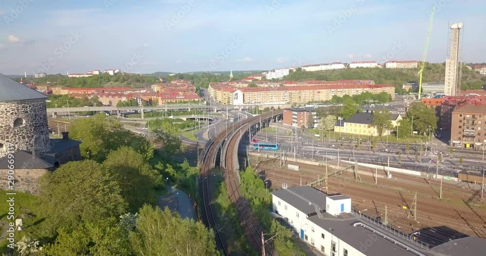 Aerial view drone flies forward over train tracks and traffic, daytime cityscape Gothenburg Sweden. Aerial view drone flies forward over train tracks and traffic, daytime cityscape Gothenburg Sweden.