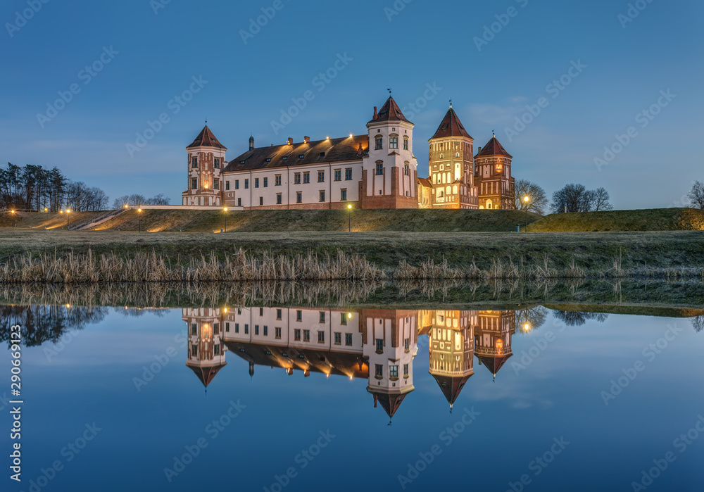 Mir, Belarus - March 28, 2019: Mir Castle complex and its reflection at sunset, UNESCO World Heritage Site.