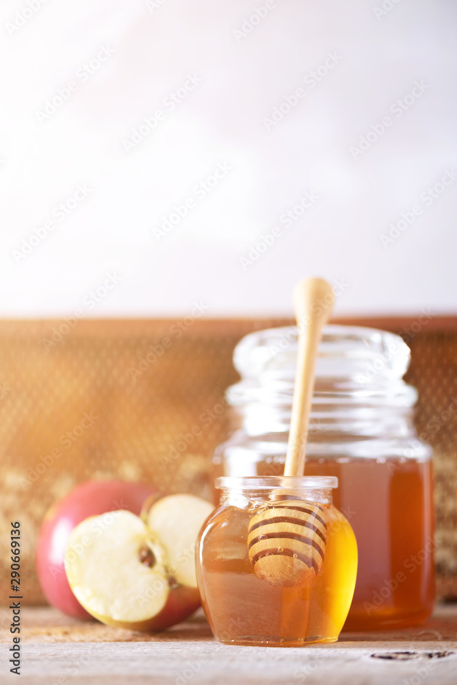 Apples with honey jar, honeycomb on grey background with copy space. Rosh hashanah jewish new year holiday celebration Apples with honey jar, honeycomb on grey background with copy space. Rosh hashanah jewish new year holiday celebration