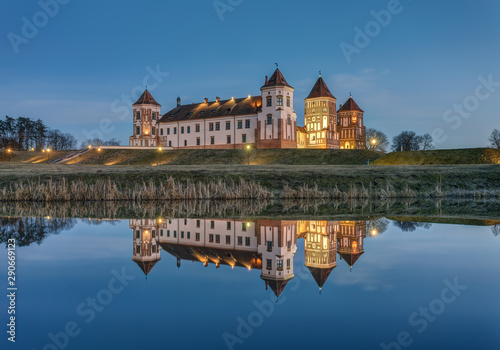 Mir, Belarus - March 28, 2019: Mir Castle complex and its reflection at sunset, UNESCO World Heritage Site.
