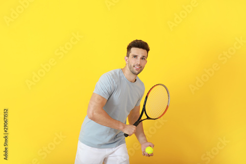 Handsome tennis player on color background © Pixel-Shot