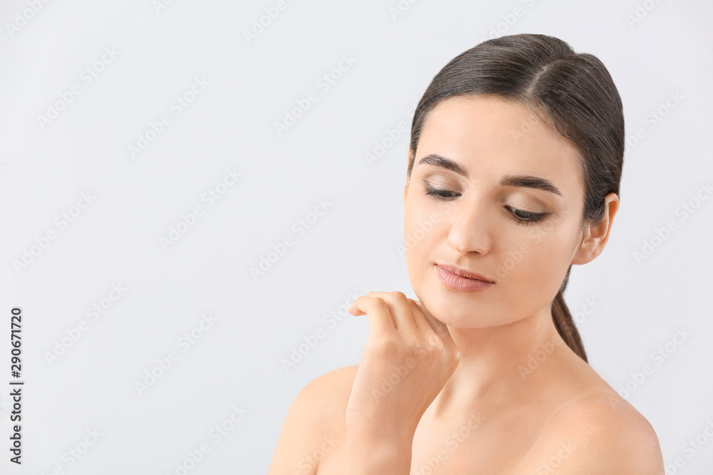 Young woman with beautiful eyebrows on light background Young woman with beautiful eyebrows on light background