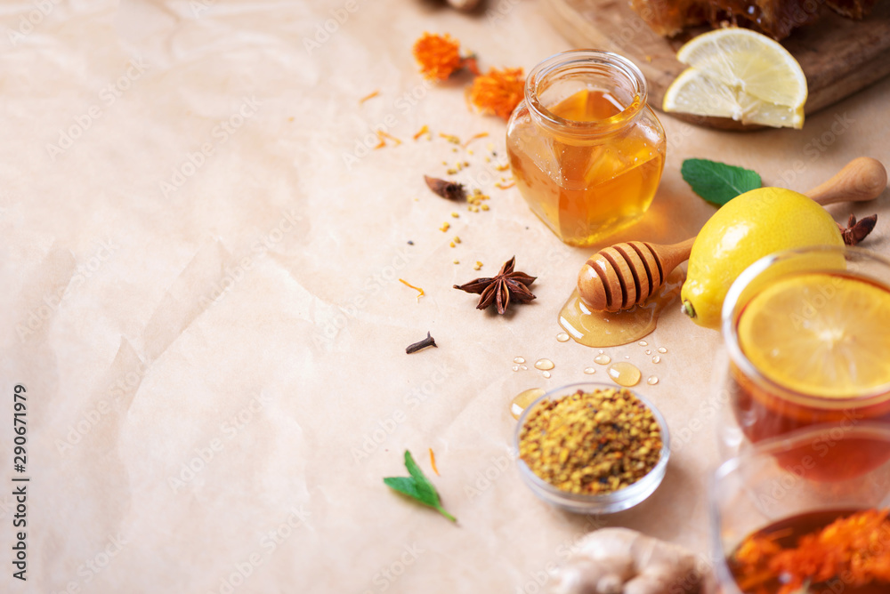 Autumn harvest concept. Set of honey and bee products, apple, lemon, spices on craft paper background. Immune system support with alternative medicine Autumn harvest concept. Set of honey and bee products, apple, lemon, spices on craft paper background. Immune system support with alternative medicine