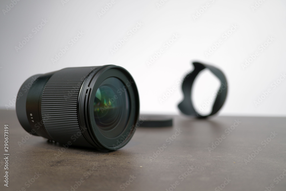 dslr camera lense, close-up view on table with smooth background