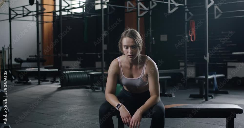 Young pretty woman resting after a workout in gym, fatigue after exercise. Young pretty woman resting after a workout in gym, fatigue after exercise.