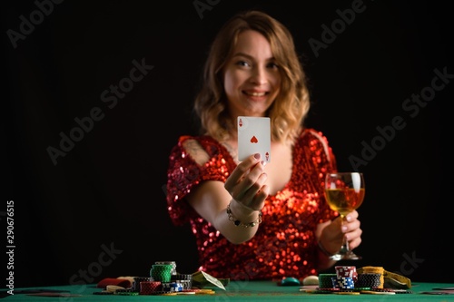 A girl plays in a casino. Focus on the cards, background for the gaming business