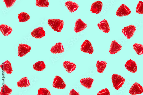 Pattern of red raspberries on blue background.