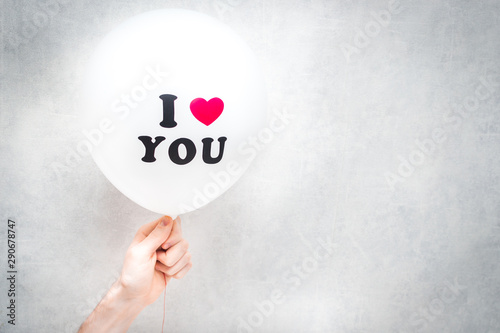 inscription I love you on a white balloon in the hand of a man. Valentine's Day
