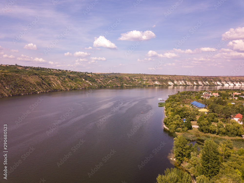 Arial view over the river and small village in autumn. Moldova republic of. Molovata village. River Dniester.