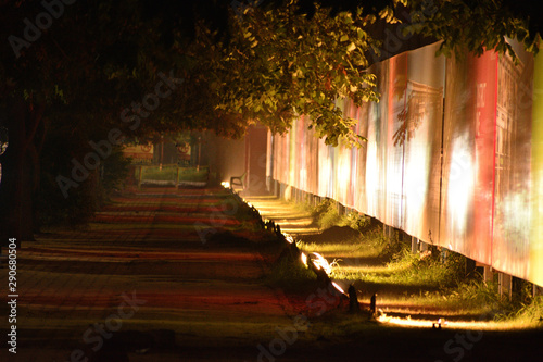 pedestrian foot path lit by flood lights early in the morning