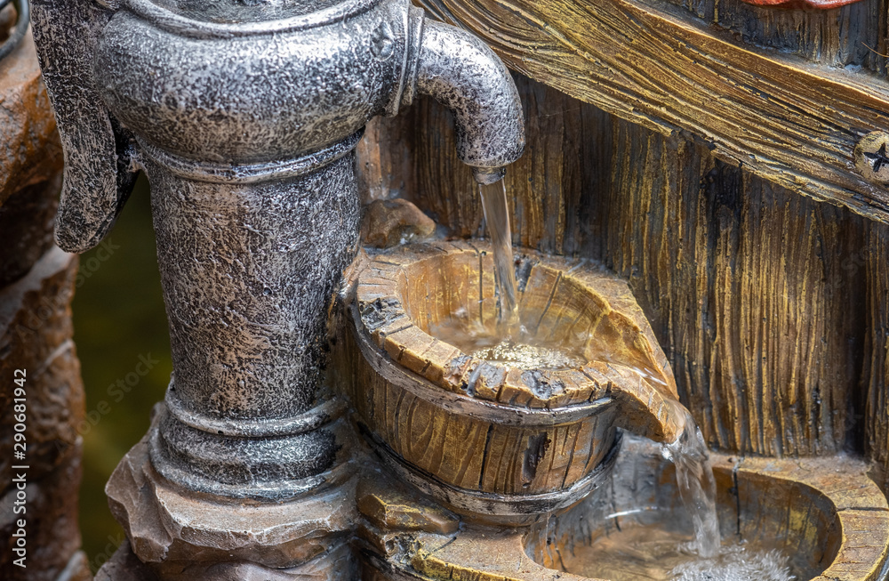 The decorative garden fountain looks like a Hand water pump The decorative garden fountain looks like a Hand water pump