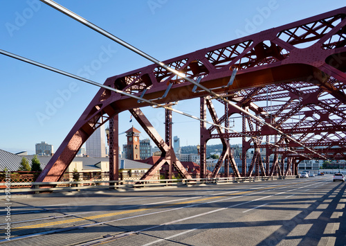 Fototapeta Naklejka Na Ścianę i Meble -  Red Truss Buscle Broadway bridge across the Willamette River in Down Town Portland at sunny day