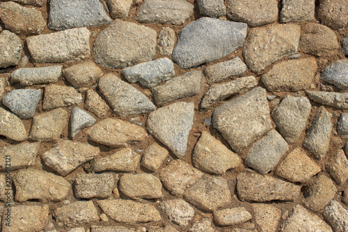 Vintage stone wall background. Stonework masonry closeup details.