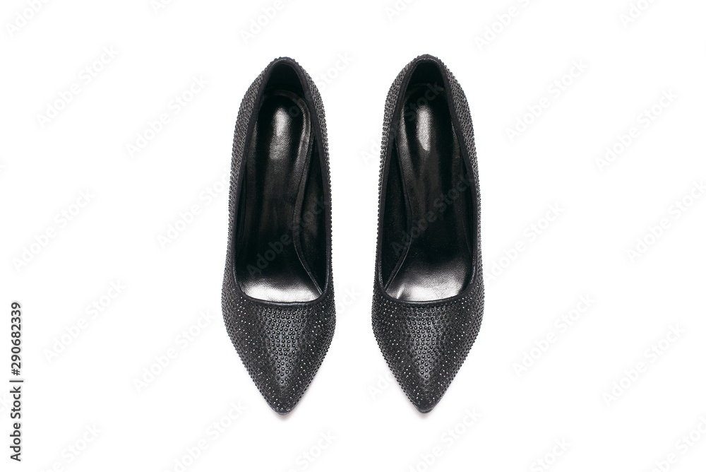Black high heels shoes with artificial rhinestones isolated on white background. Black high heels shoes with artificial rhinestones isolated on white background.