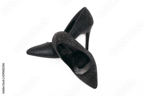Black high heels shoes with artificial rhinestones isolated on white background.