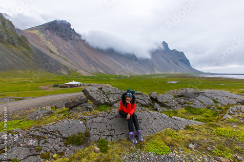 Woman asian enjoy of Popular tourist attraction. Location famous place Stokksnes cape, Vestrahorn (Batman Mountain), Iceland