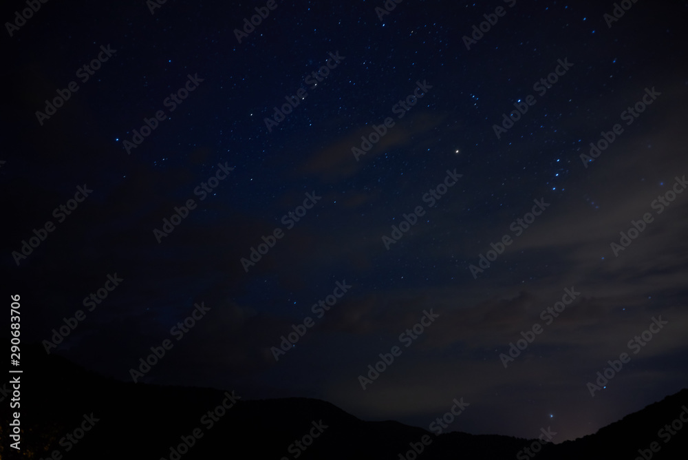 Stars in the night sky overhead. Night starry sky over the mountains. Stars and constellations in the sky.