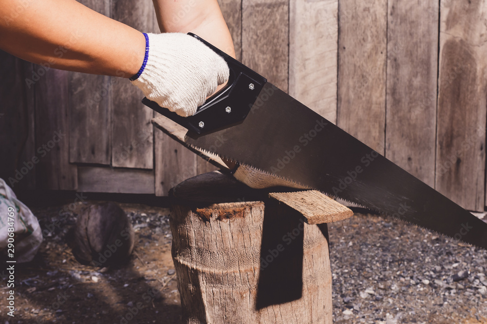 construction man workers in blue shirt with Protective gloves working with saw construction man workers in blue shirt with Protective gloves working with saw