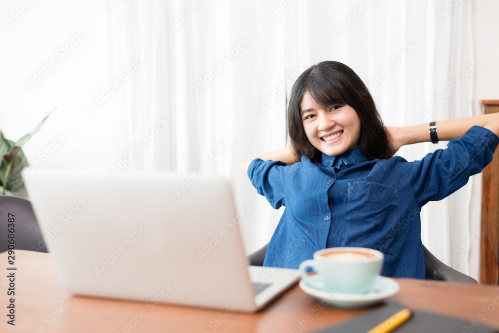 Young woman or student using laptop sitting at coffee shop. Happy girl working online or studying and using notebook. Freelance business concept. Young woman or student using laptop sitting at coffee shop. Happy girl working online or studying and using notebook. Freelance business concept.