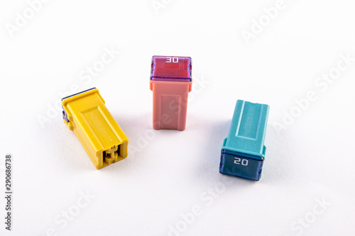 PAL blade normal profile Japan fuses with different ampers on isolated white backgrounds. Electric car parts.