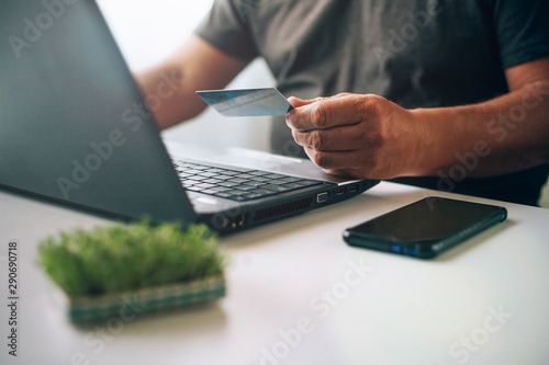 Old man shopping online with credit card. Older society adapting to news technologies.