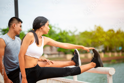 Couples who take care of their health by exercising happily in the city. Health care concept