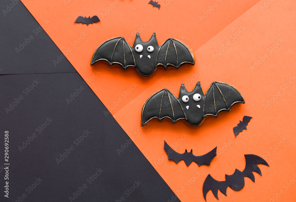 Fototapeta premium Halloween conten parties and decorations. Black-orange background and gingerbread cookies.