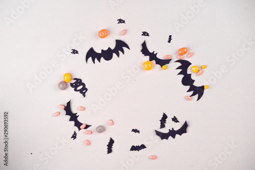 Halloween party content. Black bats of different sizes on a plain background.