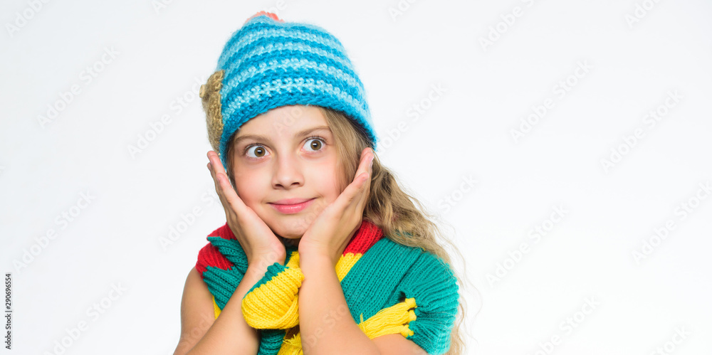Girl long hair happy face white background. Kid wear warm soft knitted blue hat and long scarf. Warm woolen accessories. Hat and scarf keep warm. Which fabrics will keep you warmest this winter Girl long hair happy face white background. Kid wear warm soft knitted blue hat and long scarf. Warm woolen accessories. Hat and scarf keep warm. Which fabrics will keep you warmest this winter