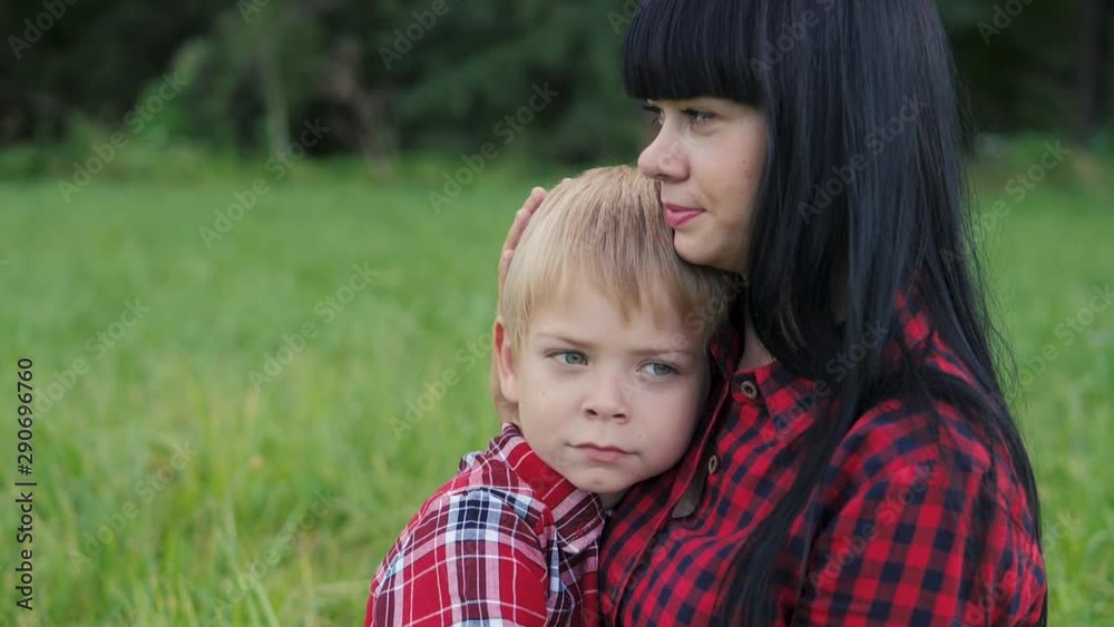 happy family mom and son concept . mom tender childhood video . slow motion video . mom a brunette girl gently hugs takes care of the boy son blonde outdoors lifestyle happy family mom and son concept . mom tender childhood video . slow motion video . mom a brunette girl gently hugs takes care of the boy son blonde outdoors lifestyle