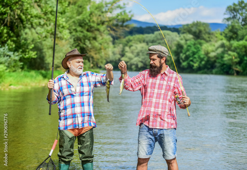 Fisherman with fishing rod. Activity and hobby. Fishing freshwater lake pond river. It is not sport, it is obsession. Bearded men catching fish. Mature man with friend fishing. Summer vacation