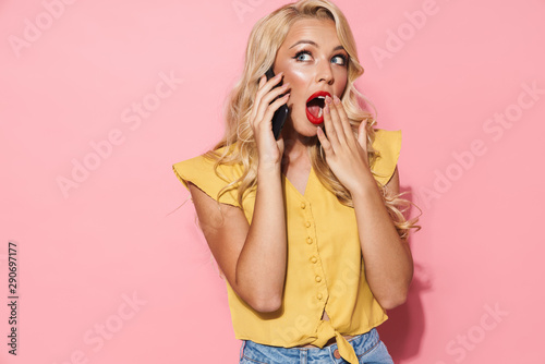 Image of surprised woman smiling and talking on cellphone