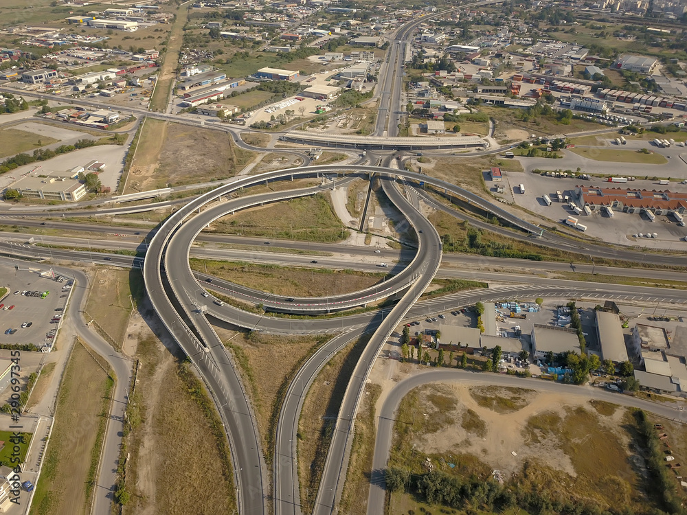Aerial high drone in 4K flight over evening road traffic in Bucharest, Romania. Highway and overpass with cars and trucks, interchange, two-level road junction in the big city. Top view. Aerial high drone in 4K flight over evening road traffic in Bucharest, Romania. Highway and overpass with cars and trucks, interchange, two-level road junction in the big city. Top view.