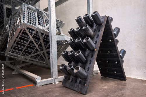 Premises for production, factory, rack with bottles of wine
