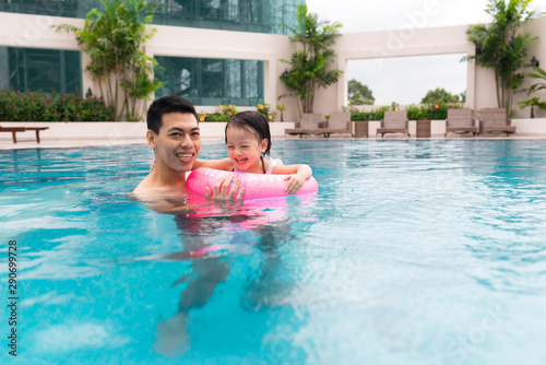 Happy family in swimming pool. Summer holidays and vacation concept © makistock