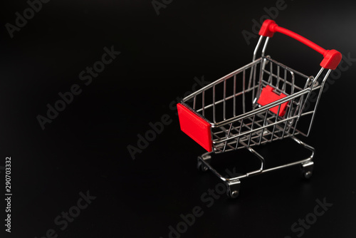 Shopping cart on dark background with copy-space